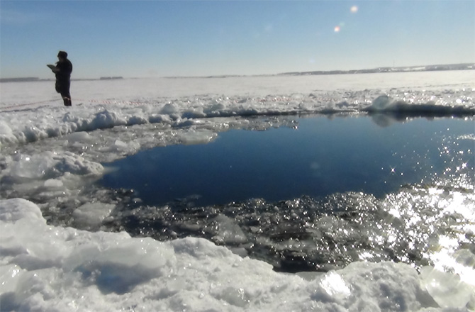 โพรงบนน้ำแข็งที่พบบนผิวทะเลสาบเชลยาบินสค์ <wbr>รัสเซีย <wbr>คาดว่าอาจเกิดจากชิ้นส่วนของอุกกาบาตตกใส่<br />
